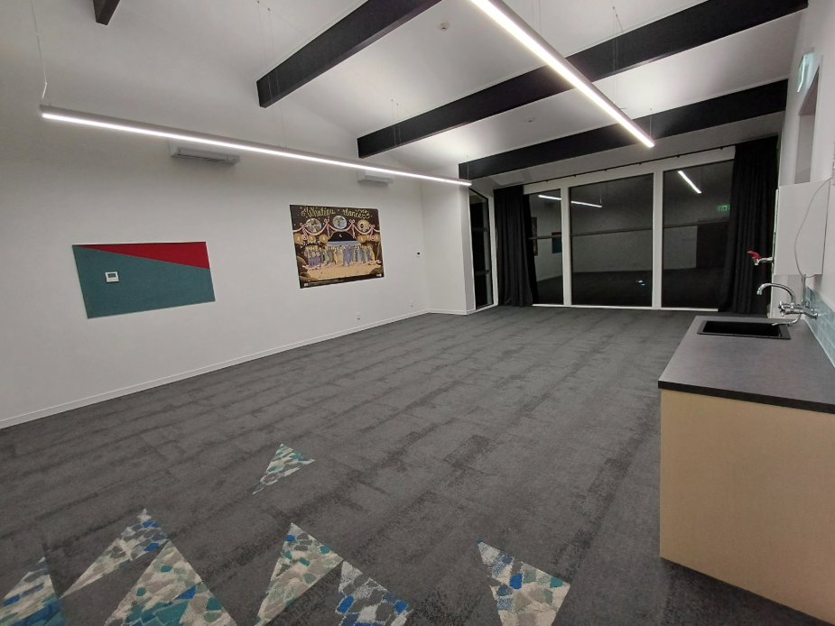 Meeting room with orange feature wall, long table and wall-mounted screen