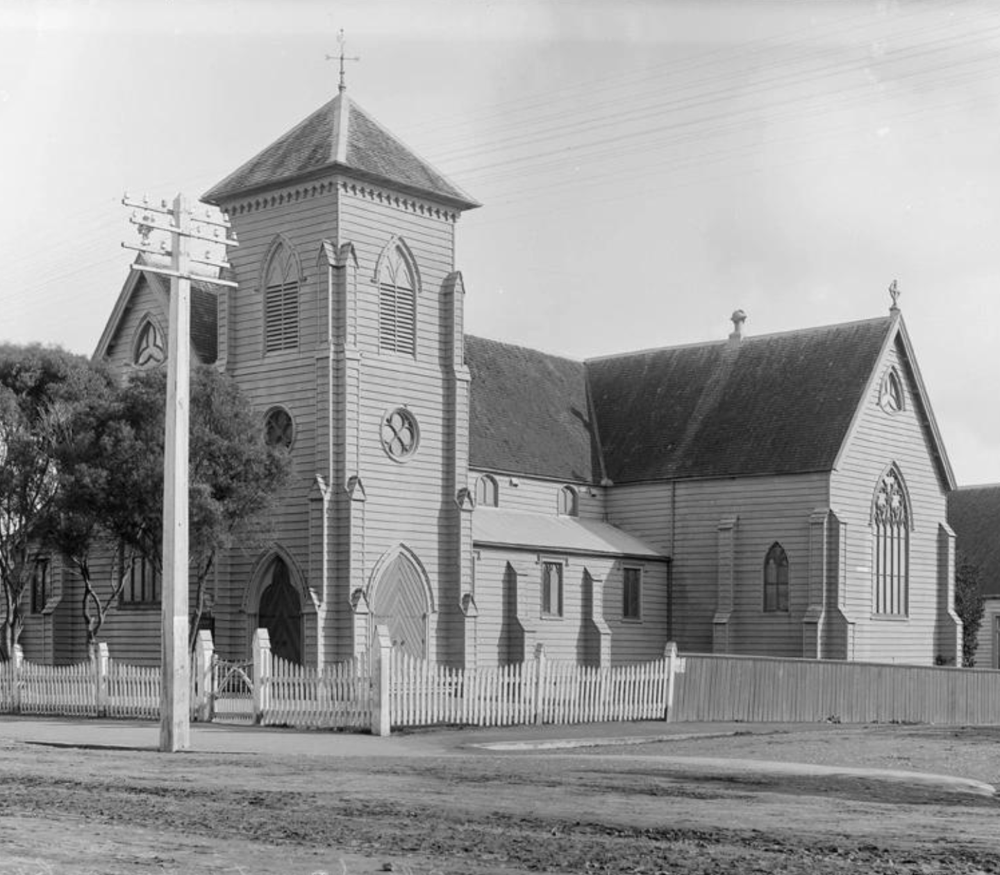 Historic timber church exterior with tower, black and white archival photograph