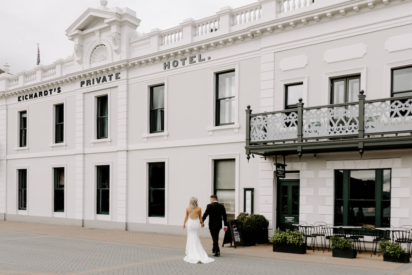 White heritage hotel facade with ornate balcony on the Queenstown waterfront