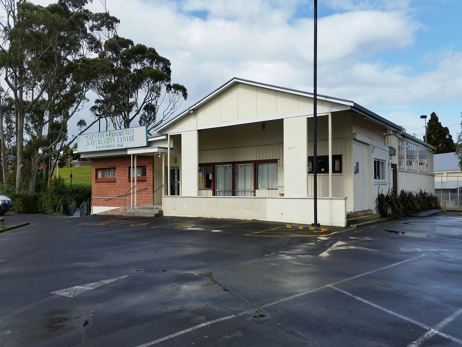 Cream and brick community and recreation centre building with car park