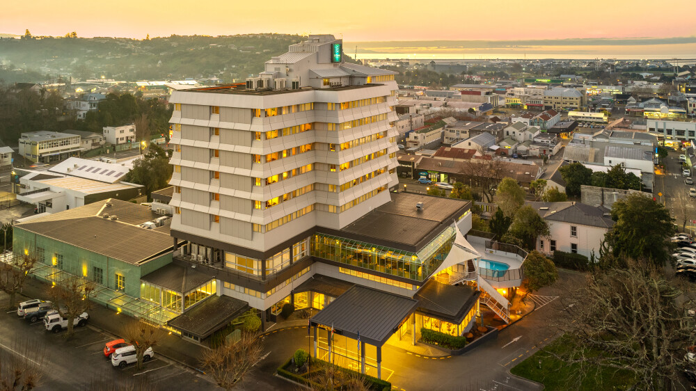 Aerial view of multi-storey hotel building in town centre at dusk