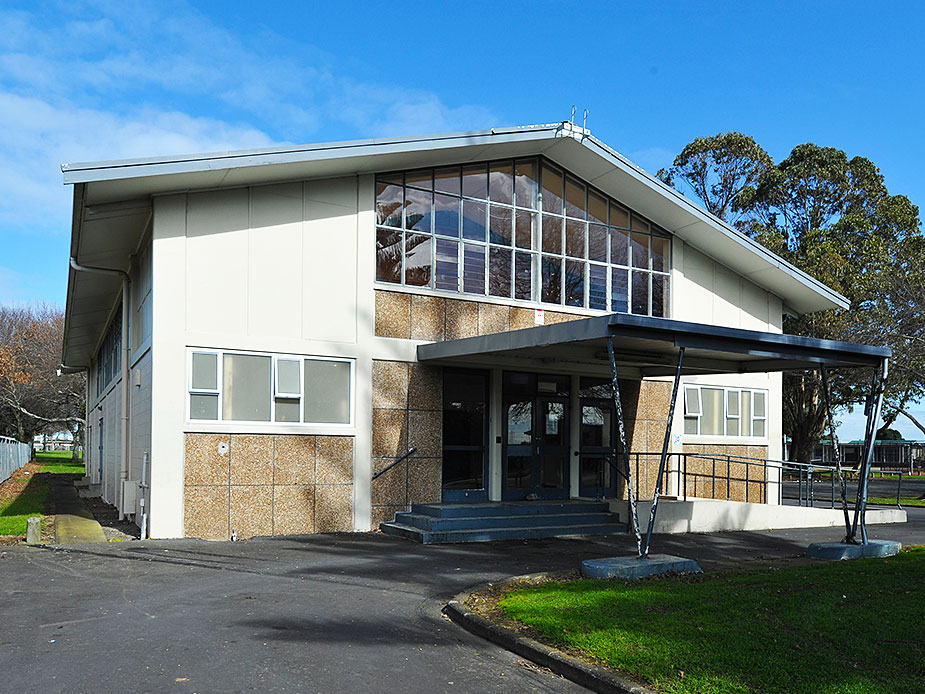 Two-storey community hall exterior with wide glazing and aggregate cladding