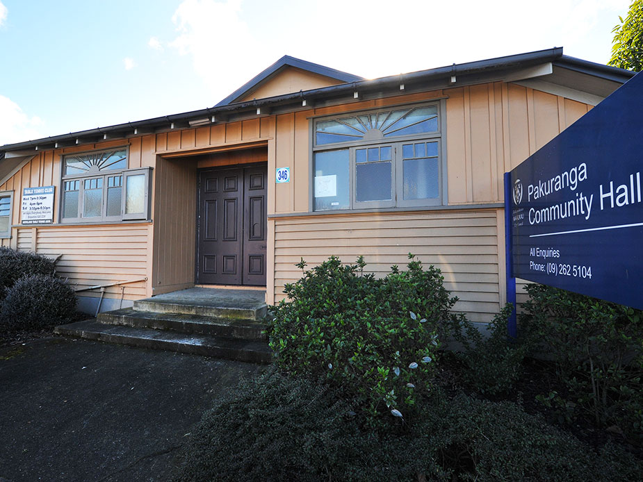 Close-up of timber hall entrance with dark door and community hall sign