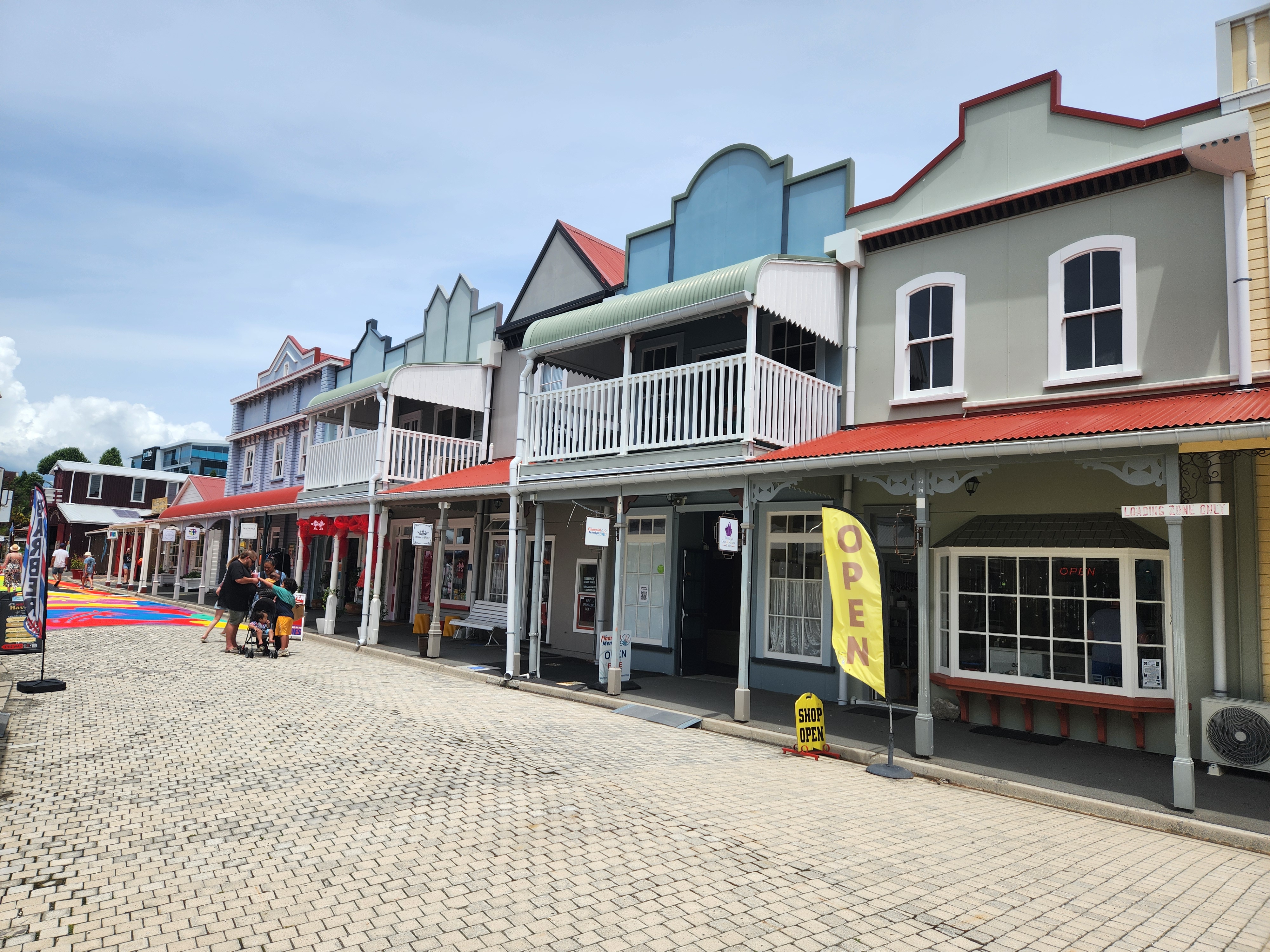 Historic building row with varied storefronts on paved street