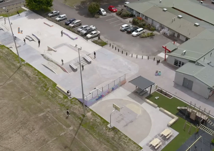 Aerial view of a community centre and surrounding car park and skate park