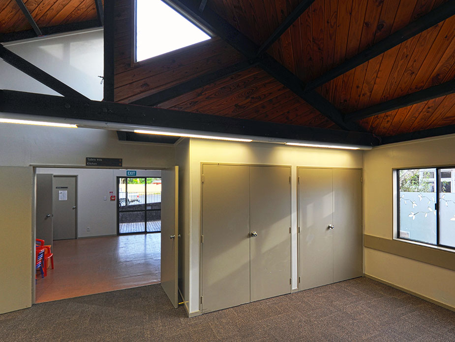 Hall interior with timber ceiling, storage doors and windows