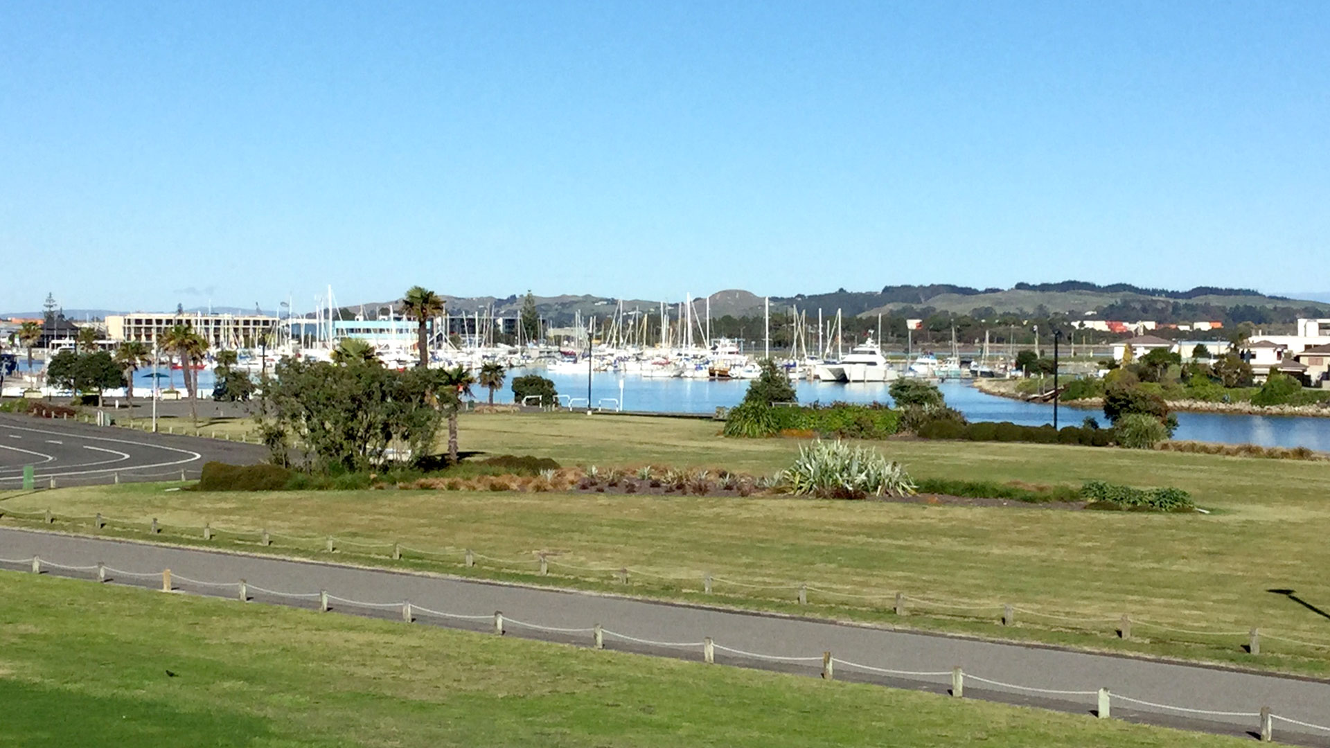 View across lawn to marina with moored vessels