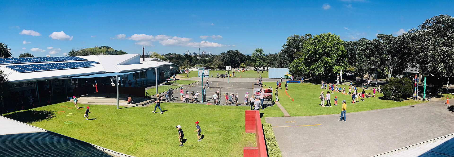 School grounds and playing field with building and trees visible