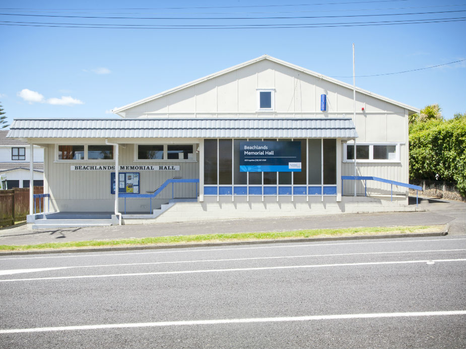 Single-storey community hall with signage on roadside frontage