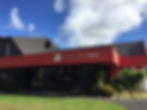 Low-resolution exterior of a building with red roof
