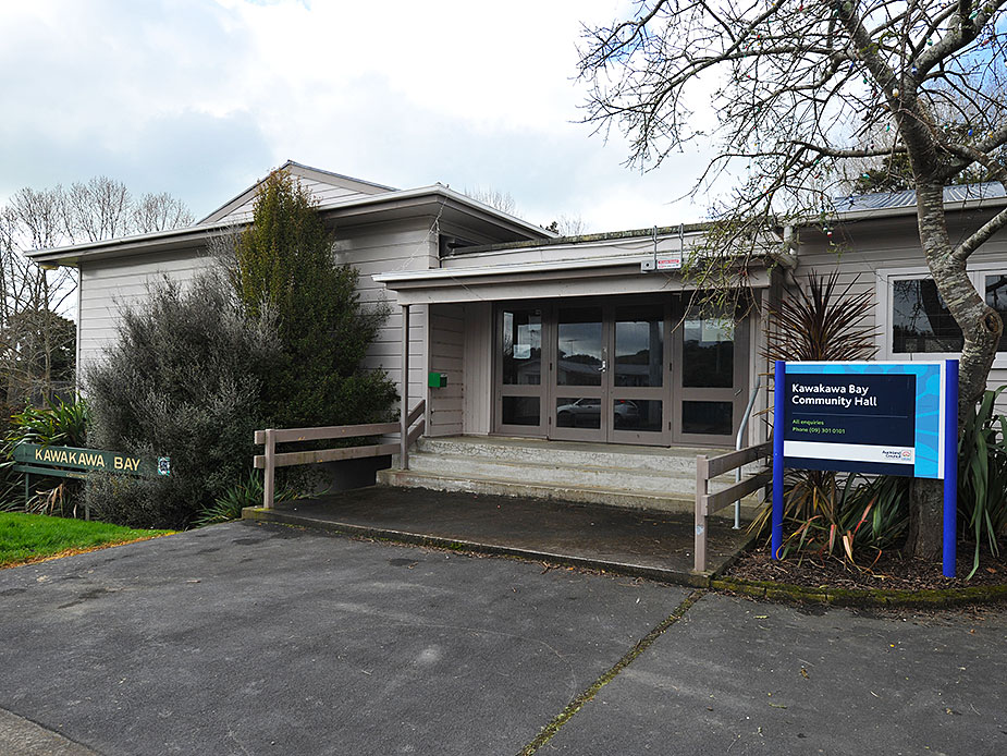 Low-set community hall exterior with car park and signage