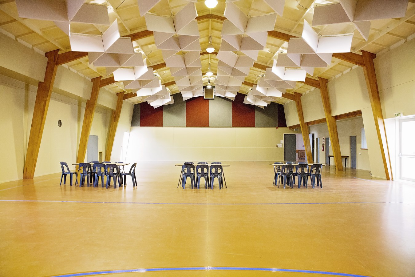 Large hall with timber-framed ceiling, tables and chairs set out