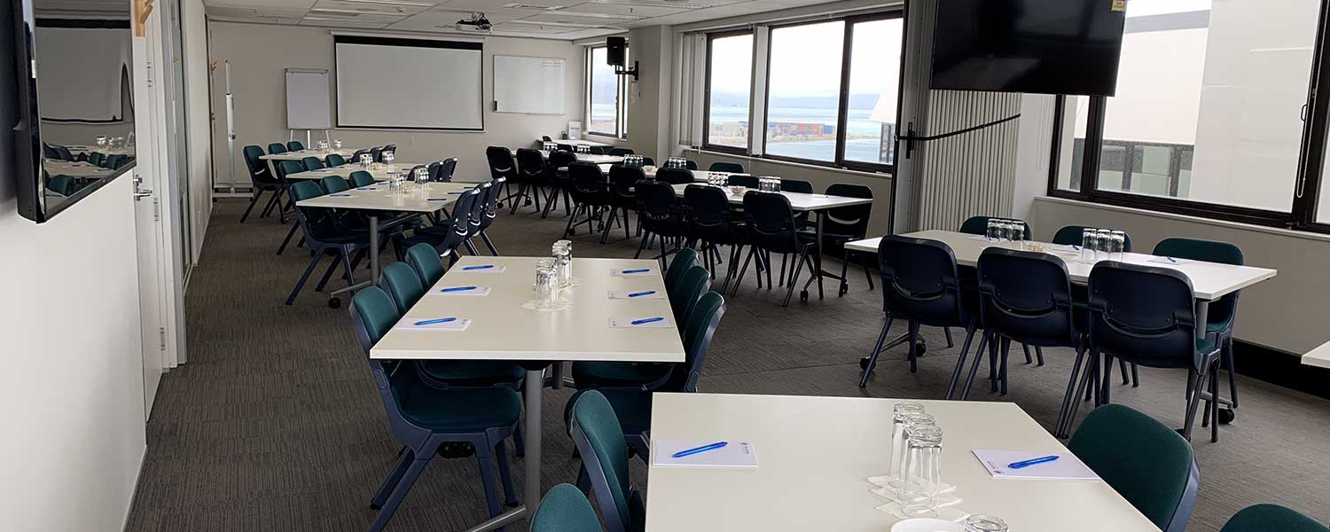 Conference room with tables and chairs set for a meeting