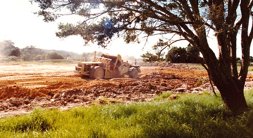 Earthworks and grading of sports grounds with trees and machinery