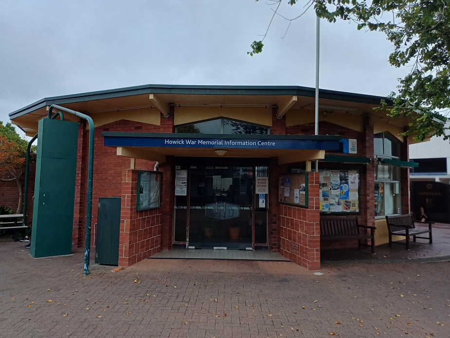 Brick community hall building with covered entry, Howick War Memorial Information Centre signage