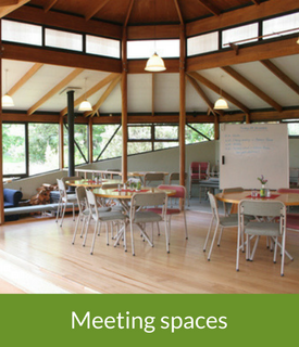 Octagonal timber meeting room with tables, chairs, and whiteboards, labelled Meeting spaces