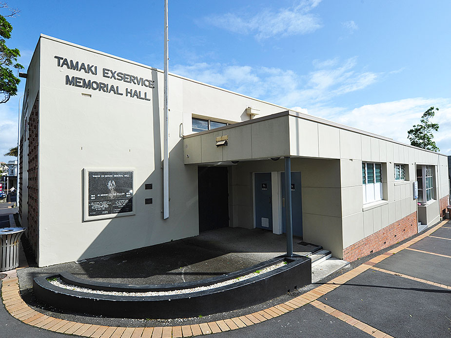 Single-storey hall building exterior with signage and car park
