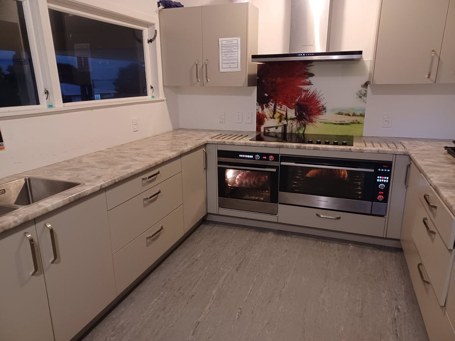 Catering kitchen with double oven, cooktop, and laminate benchtops