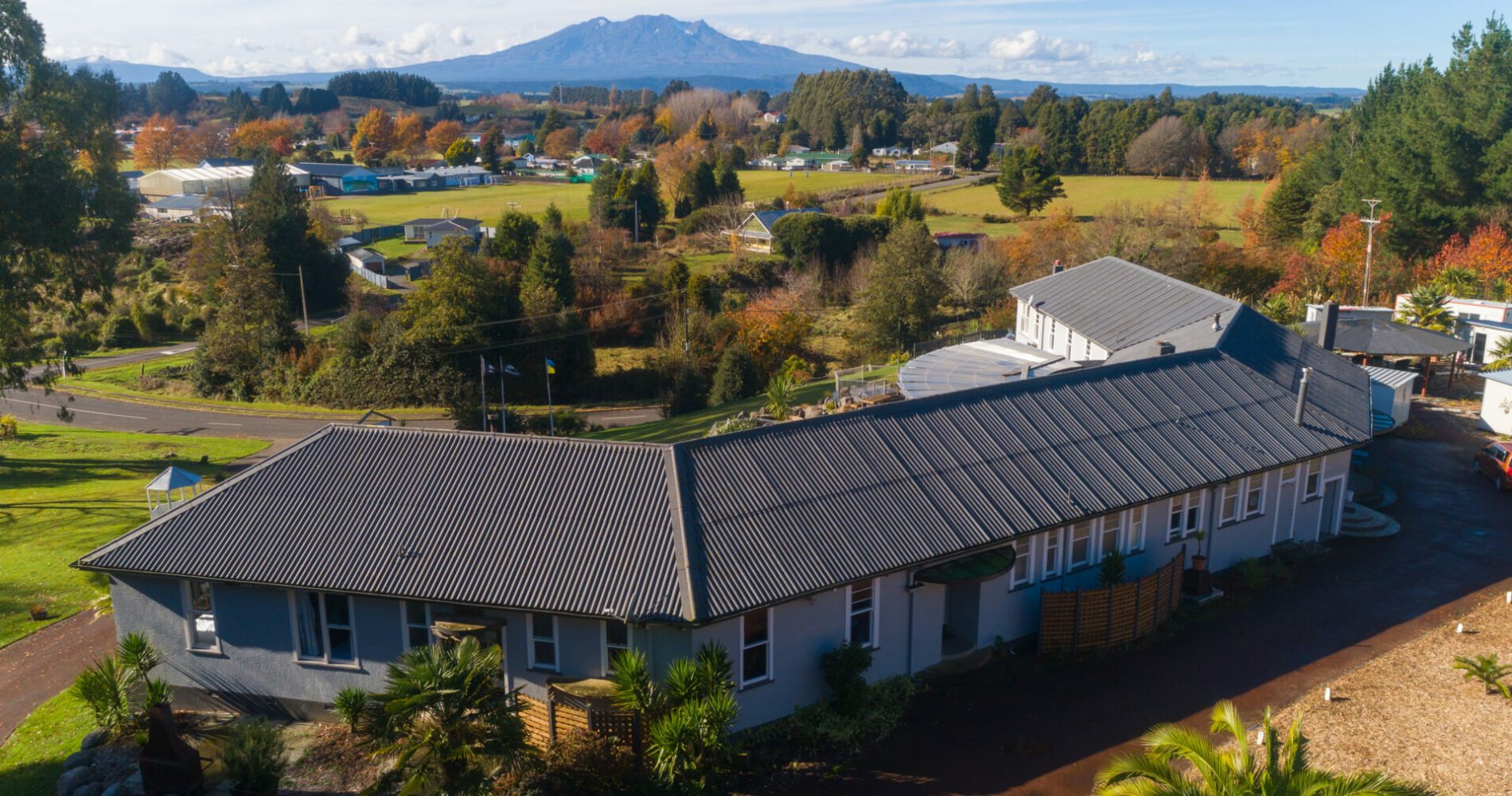 Aerial view of lodge roof and grounds with mountain visible in background