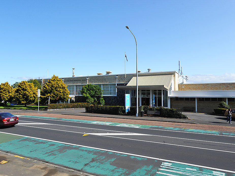 Civic hall building viewed from across the road with flagpole