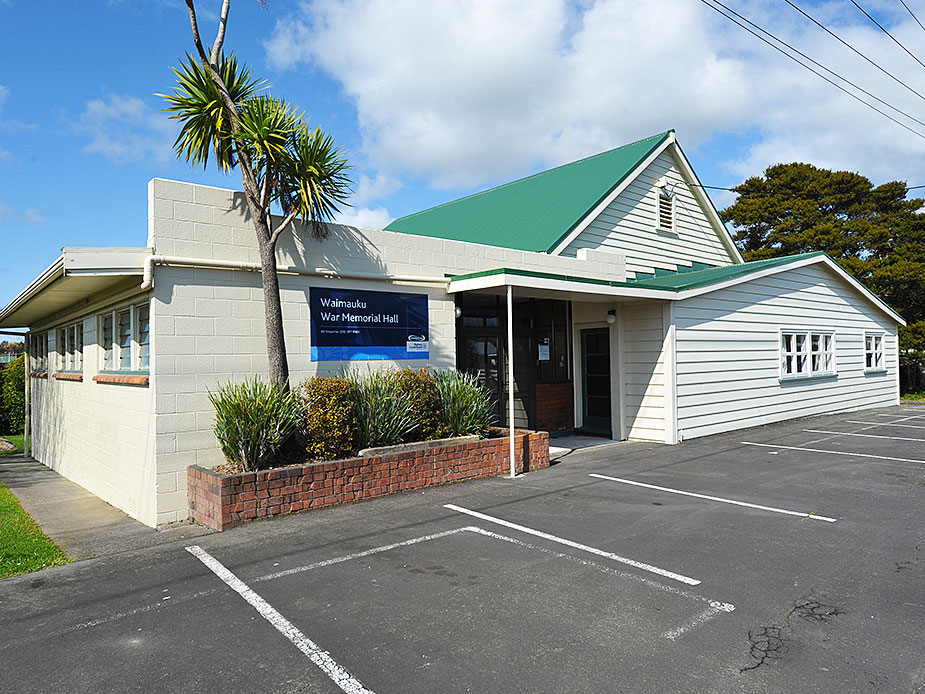 Waimauku War Memorial Hall exterior with green metal roof and small car park