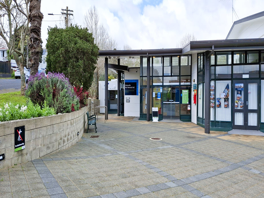Entry forecourt with curved garden wall, bench seating and glazed entrance to community hall