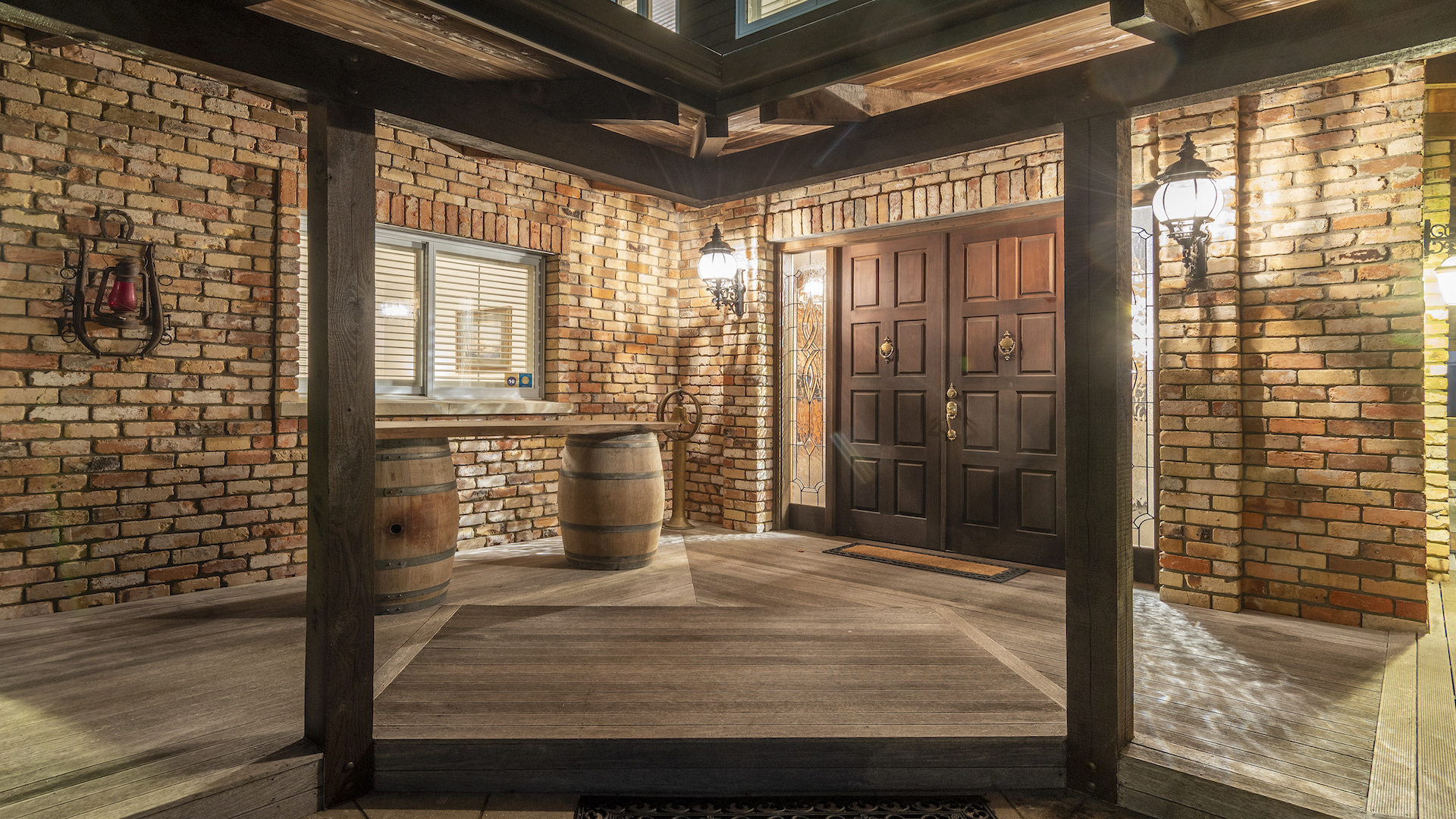 Entrance foyer with exposed brick walls, timber beams and wine barrels
