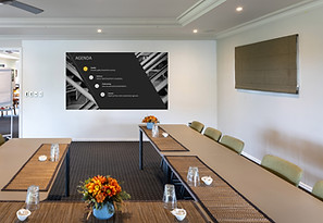 Meeting room with U-shaped table arrangement and presentation screen