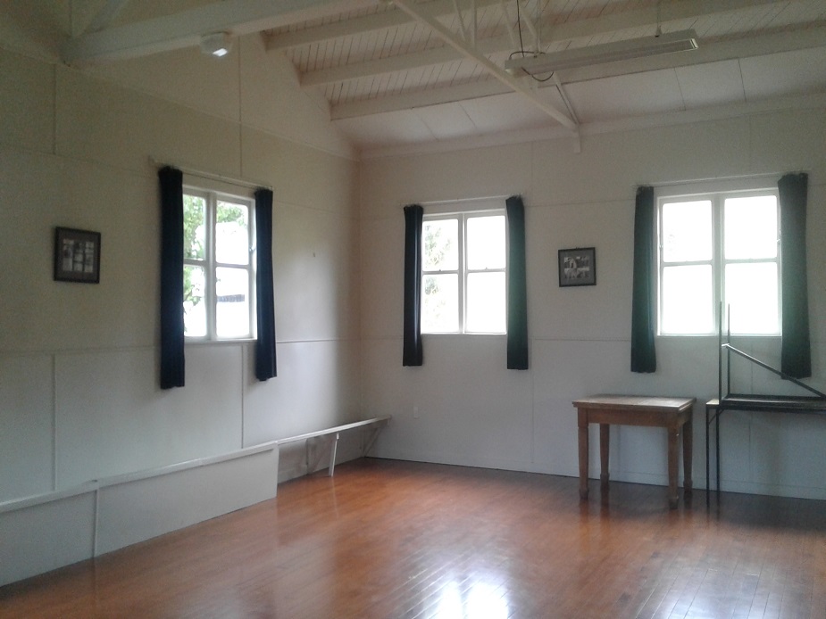Empty white hall interior with timber floor and open windows
