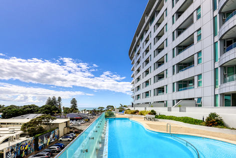 Multi-storey hotel building with pool terrace and sea view