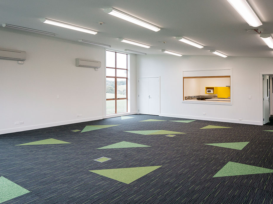 Open function room with patterned carpet tiles and servery hatch