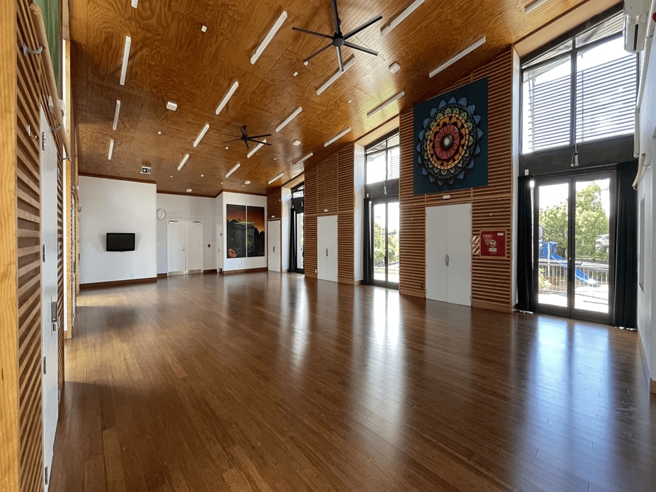 Open hall with timber ceiling, polished floor and large artwork panels