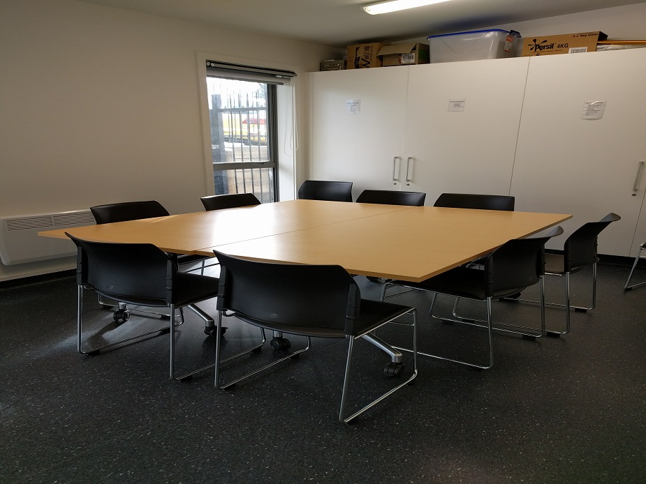 Small meeting room with square table and chairs in a circle arrangement