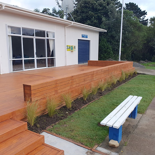 Club building with timber deck, garden bed, and bench seating
