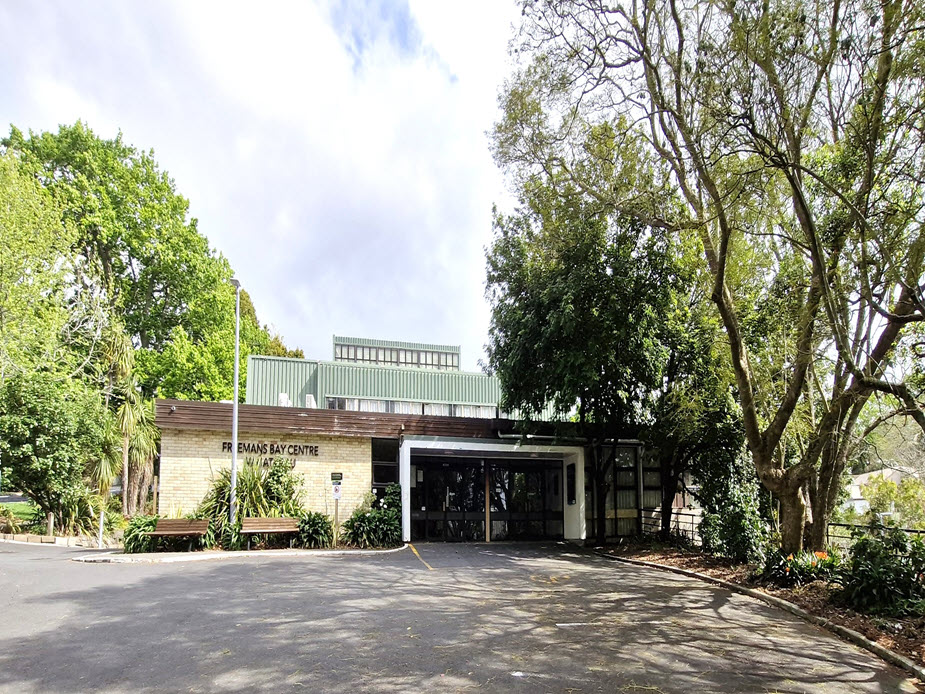 Brick and weatherboard community centre building surrounded by trees