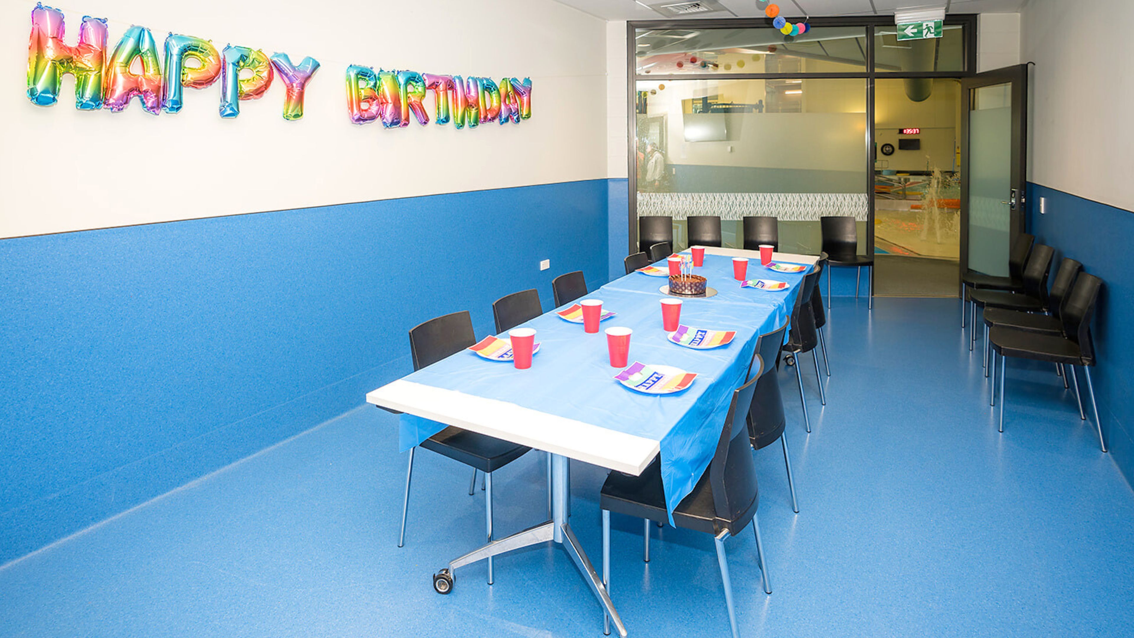 Function room set with table and chairs decorated for a birthday party