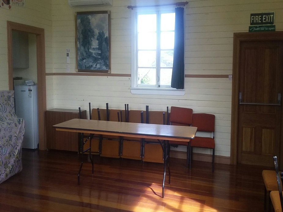 Small hall with trestle table, chairs and timber floors