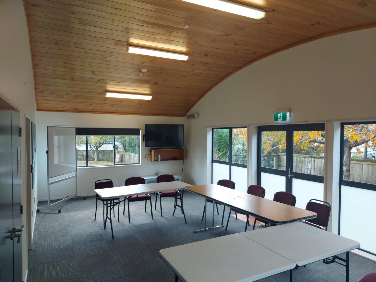 Meeting room with timber ceiling, tables in U-shape and large windows