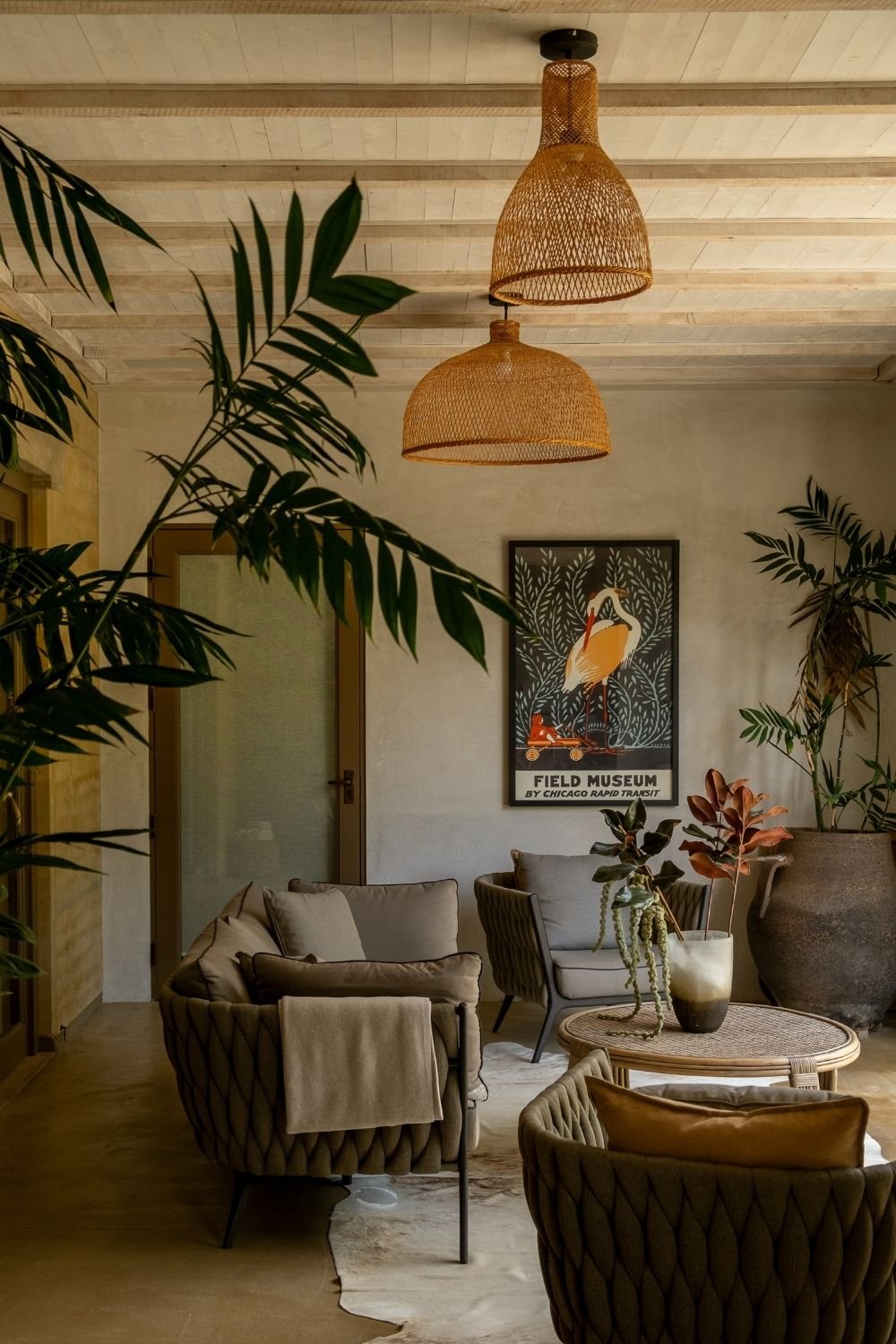 Living room with rattan pendants, neutral sofas and indoor plants