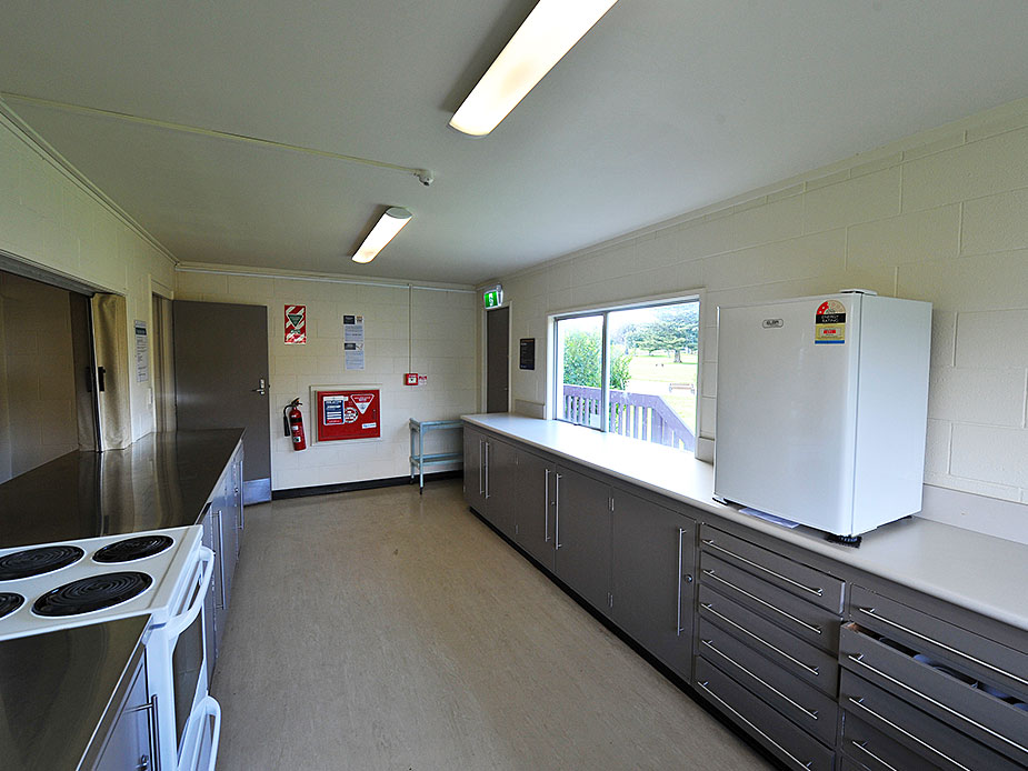 Kitchen with grey cabinetry, stove and refrigerator