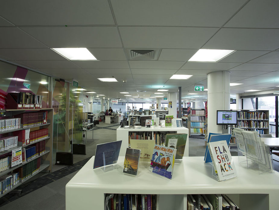 Library floor with book shelves, display stands, and featured titles on counter