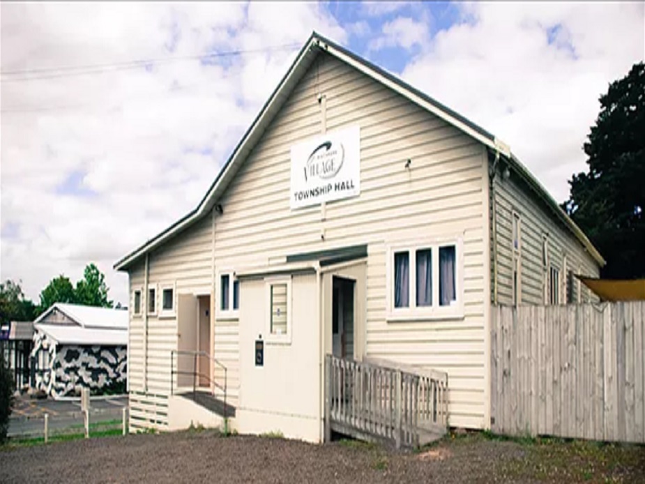 Cream weatherboard township hall with gabled roof and a Village Township Hall sign