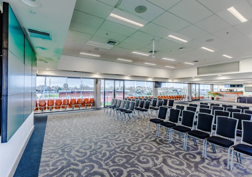 Stadium lounge with chairs in theatre layout overlooking the pitch