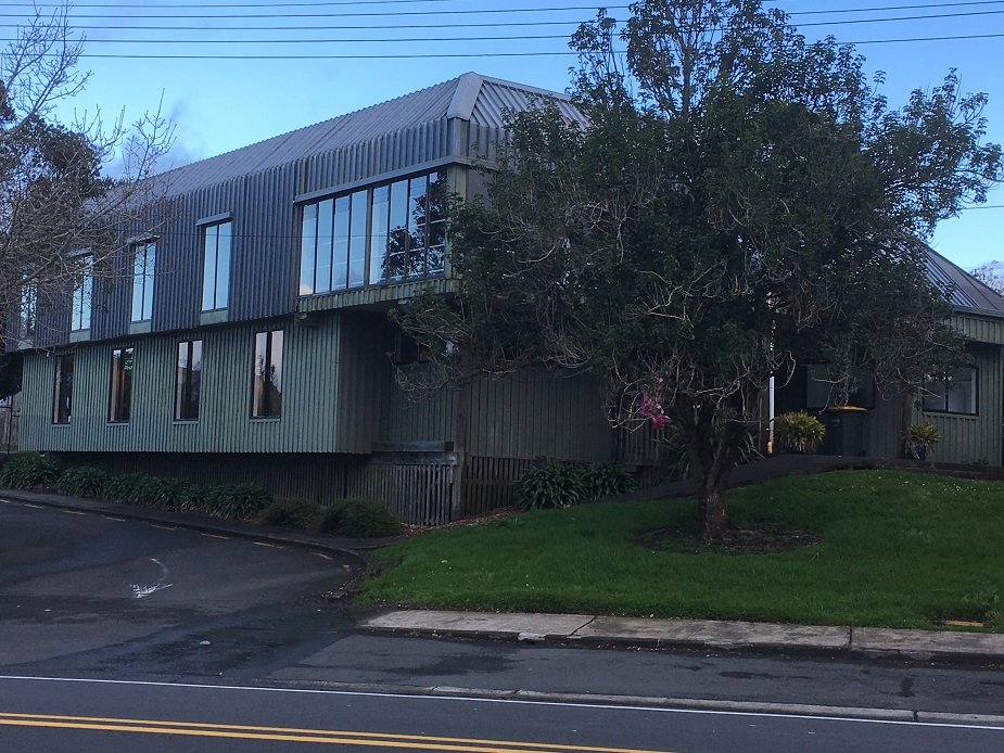 Two-storey corrugated metal clad hall building on a street corner