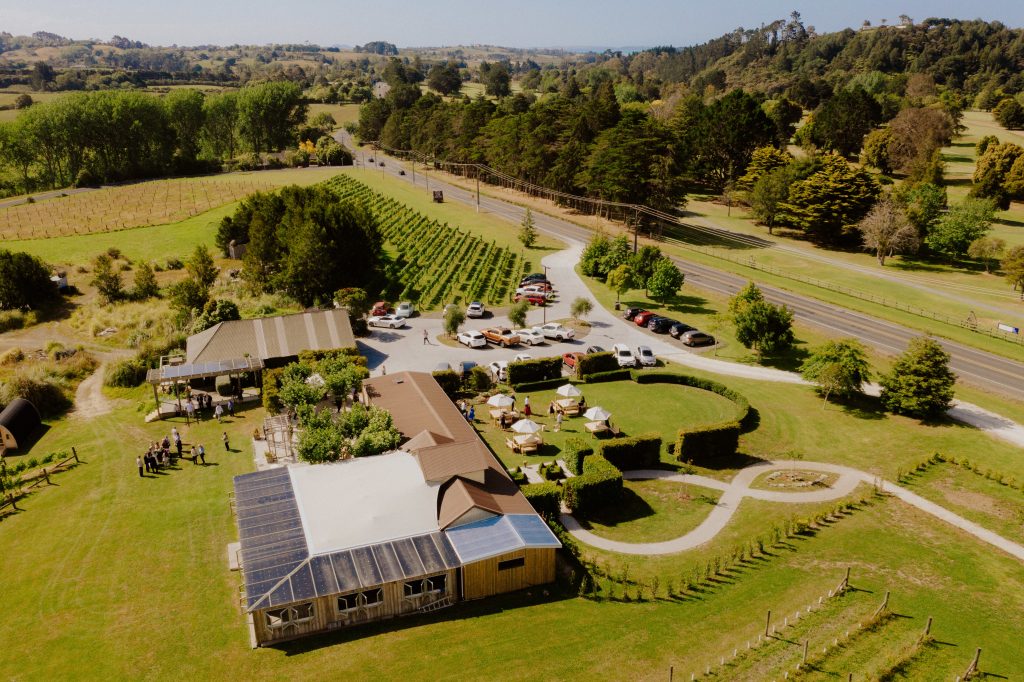 Aerial view of winery venue and vineyards with car park and marquee