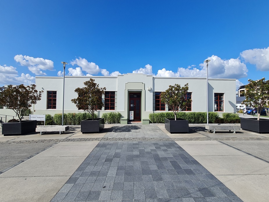 Art deco style building with symmetrical facade and paved forecourt