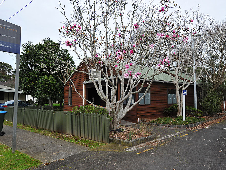 Weatherboard hall exterior with flowering tree in foreground
