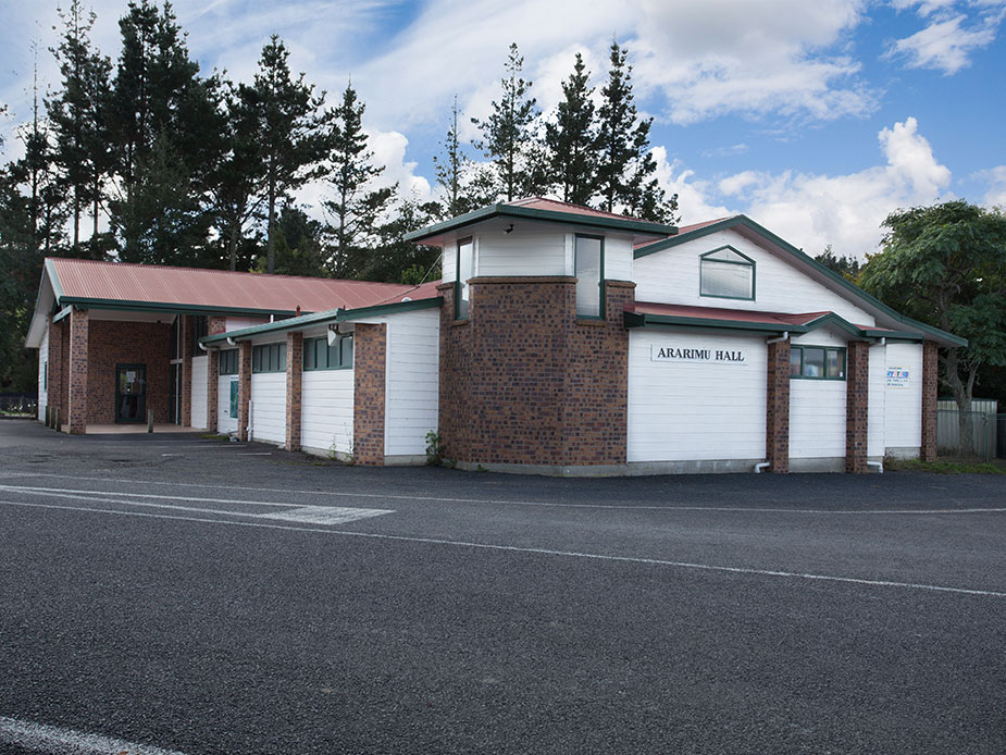 Brick and weatherboard community hall exterior with name signage