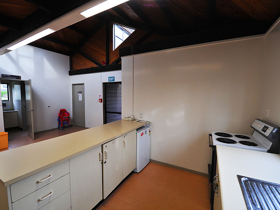 Kitchen bench with stove and appliances, timber ceiling with skylight above