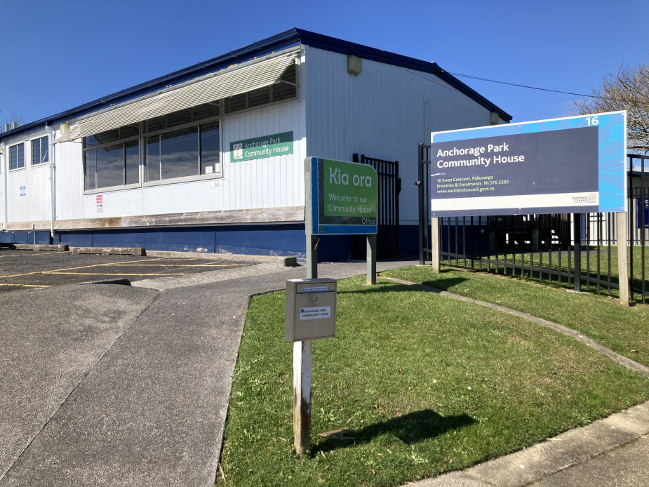 Single-storey community hall exterior with signage and car park